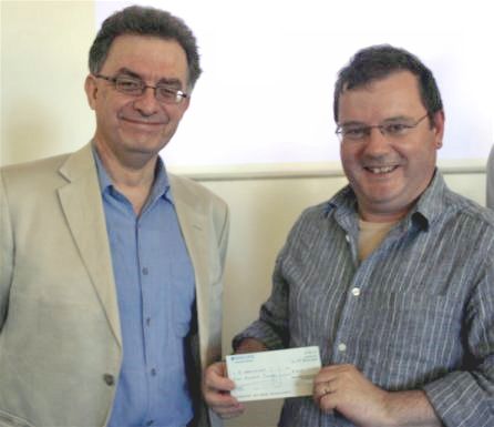 Jon Wainwright receives the first prize cheque from Chris French