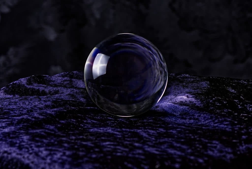 A crystal ball on top of purple velvet