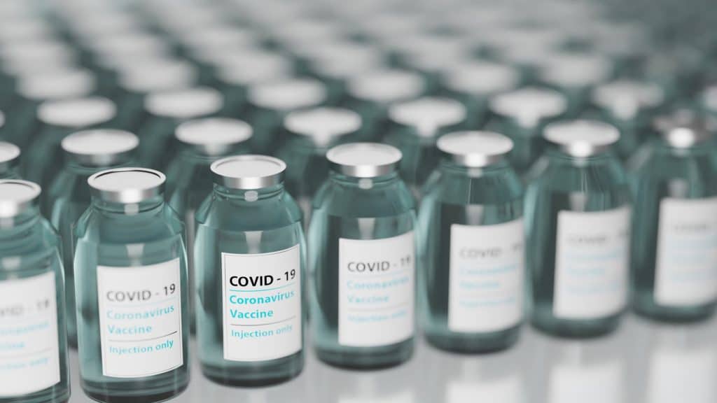 Several glass vials labelled "COVID-19 Coronavirus vaccine"