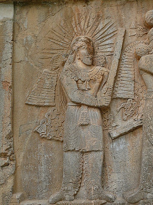 An ancient carved relief in stone showing the god Mithra, his head surrounded by lines denoting a solar halo