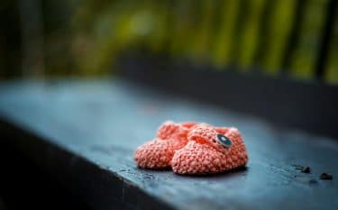 Pink baby shoes on a bench

Photo by 🇸🇮 Janko Ferlič on Unsplash

