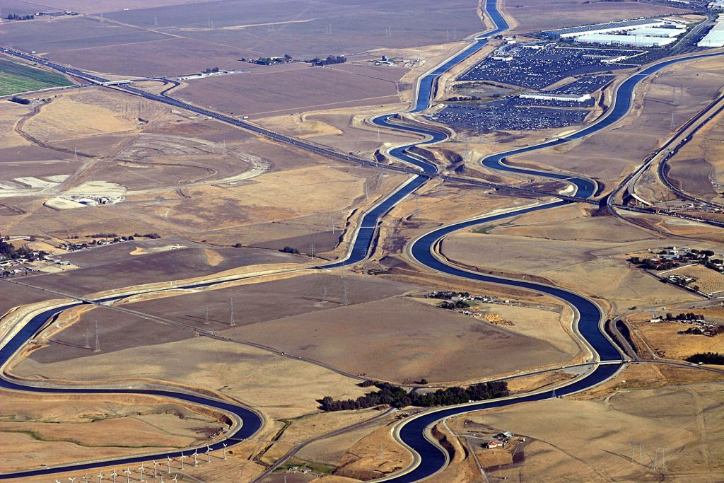 The California Aqueduct snakes through a brown valley