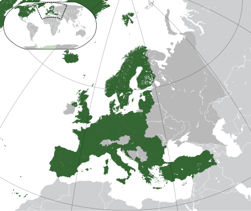 A small map of the globe in the top left has a box around Europe indicating the wider image, showing NATO member states in dark green, with non-members in grey.